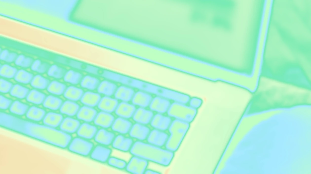 A computer keyboard with a green screen