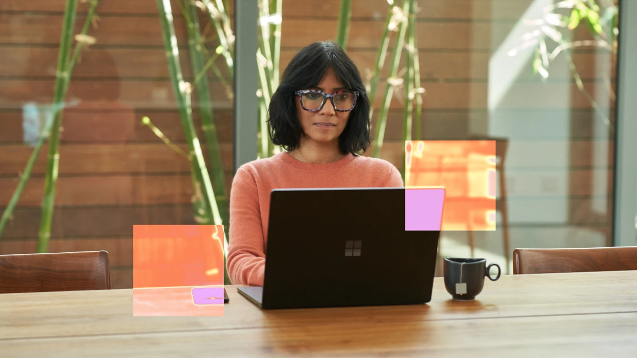 A woman sitting at a table with a laptop