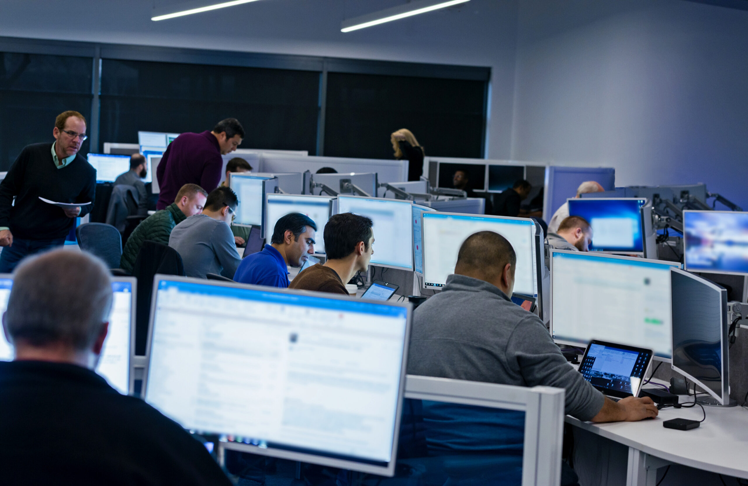 A group of people sitting at computers