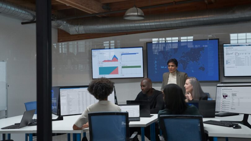 CISO (chief information security officer) collaborating with practitioners in a security operations center.