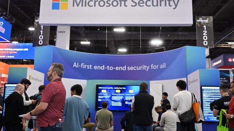 A group of people in front of a sign