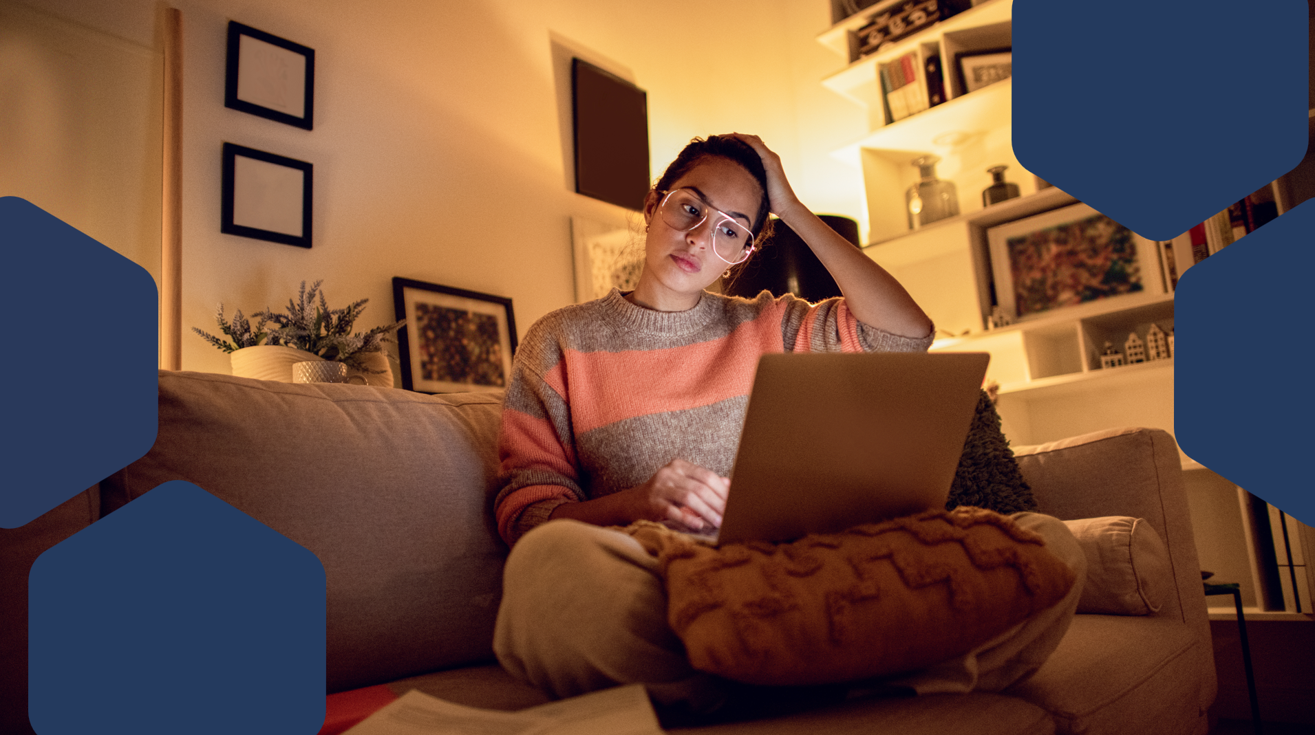 A woman sitting on a couch using a laptop
