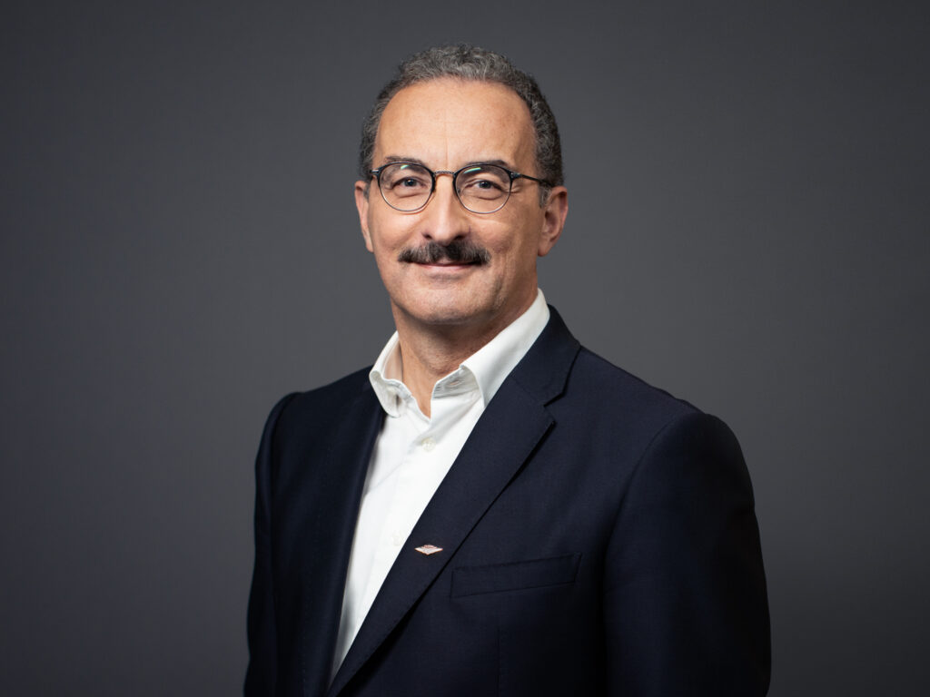 A man in a suit with gray background