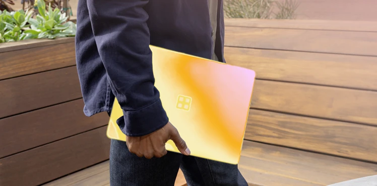 person holding computer with orange and pink scanned treatment on device.