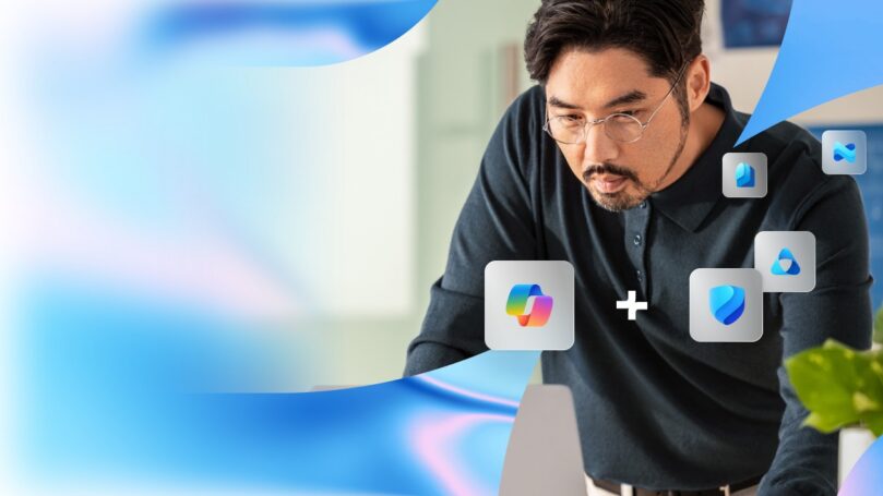 A person leaning over a desk, surrounded by floating icons of Microsoft Loop and Microsoft Defender, with abstract blue and white swirls in the background, suggesting collaboration between these tools.