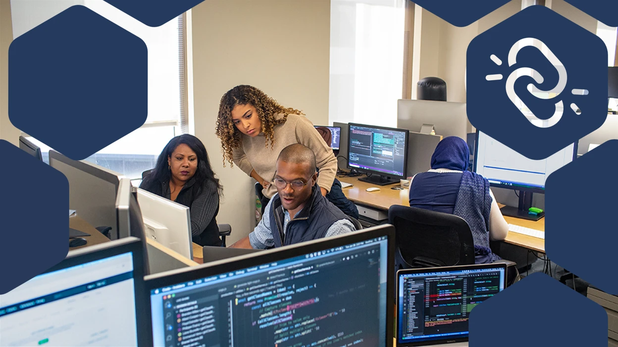 Developer manager collaborates with developer colleague in developer work space.