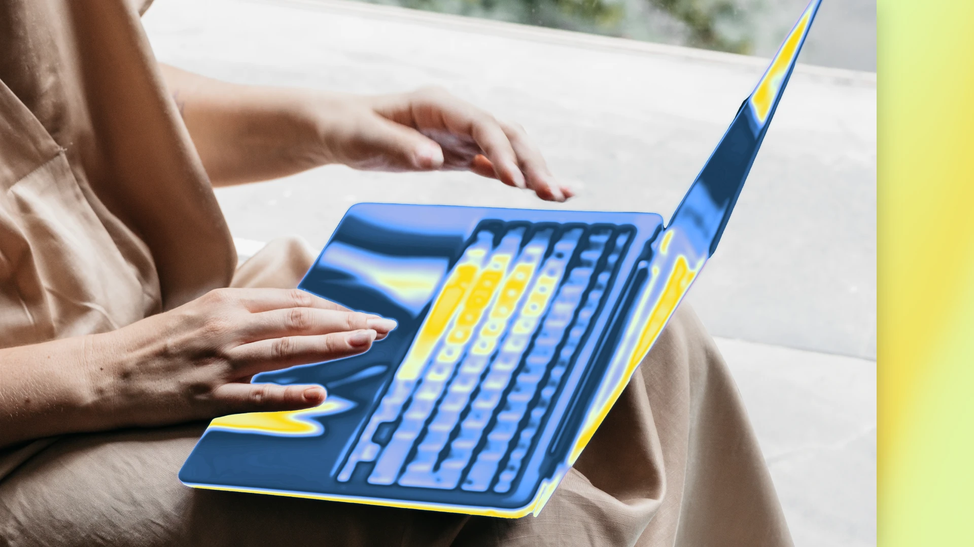 Close up photograph of hands typing on a laptop