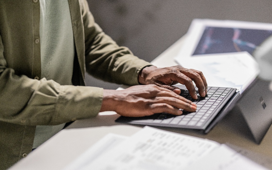 Close up of hands typing on keyboard of Surface tablet