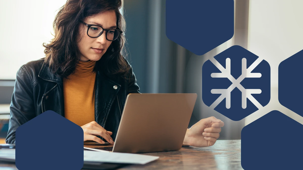 Woman with glasses typing at laptop