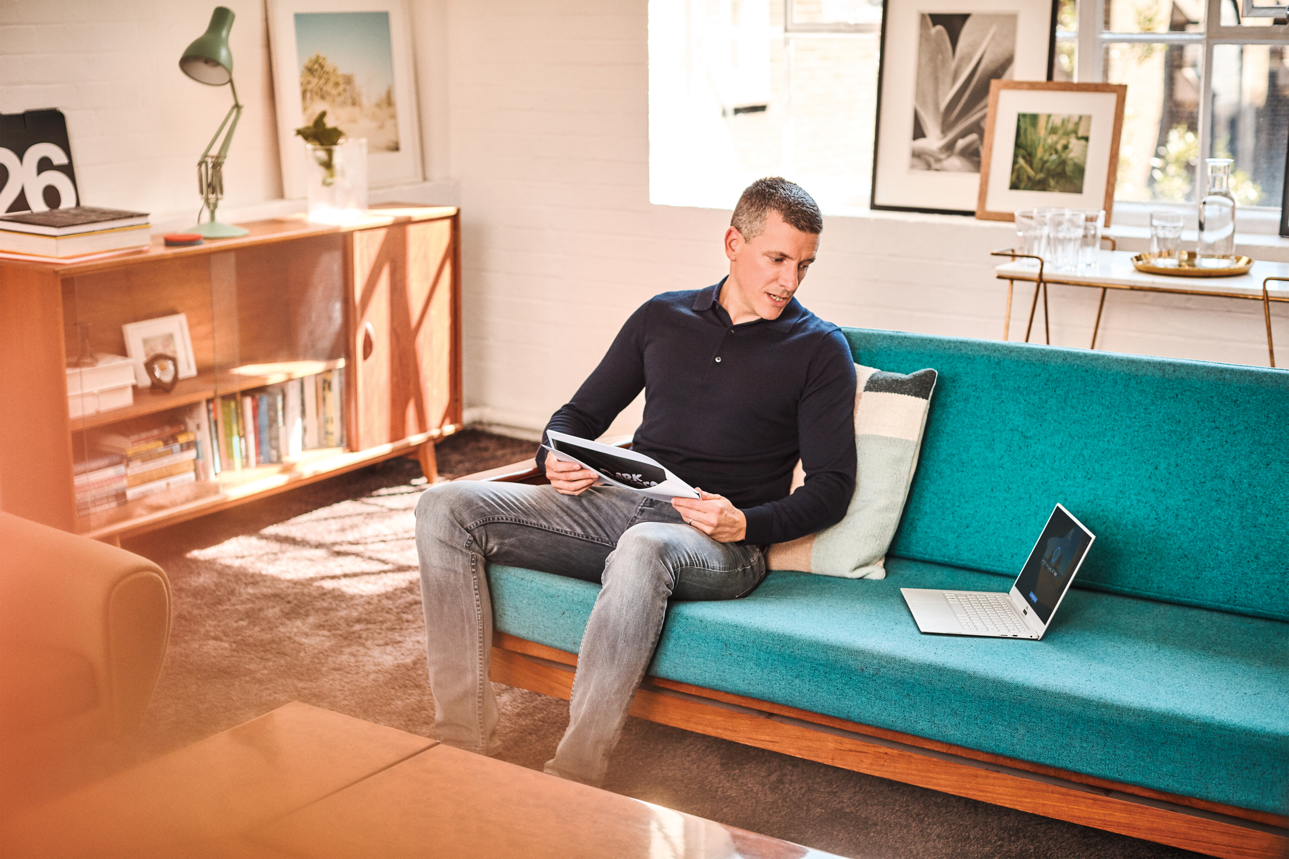 a man sitting in a room on a computer