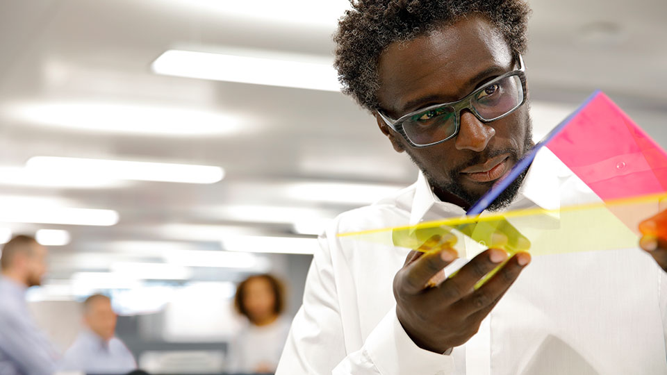 A man examines a plastic sample
