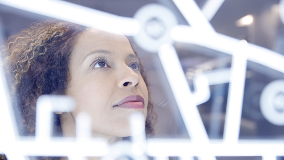 A woman looks at a digital interface.