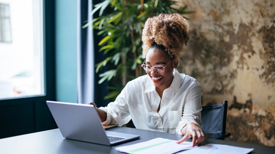 A woman looks over her startup's finances on her laptop.