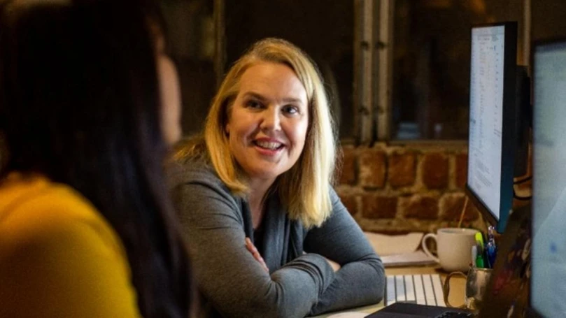 A person sitting at a desk and having a discussion