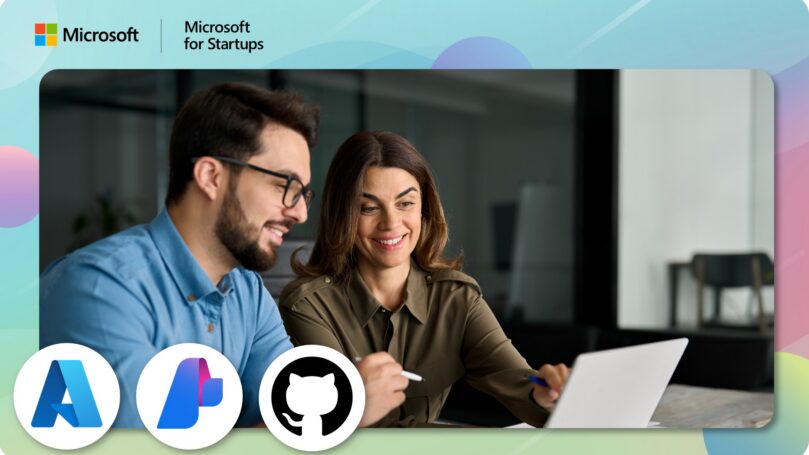 Two employees looking at a laptop screen