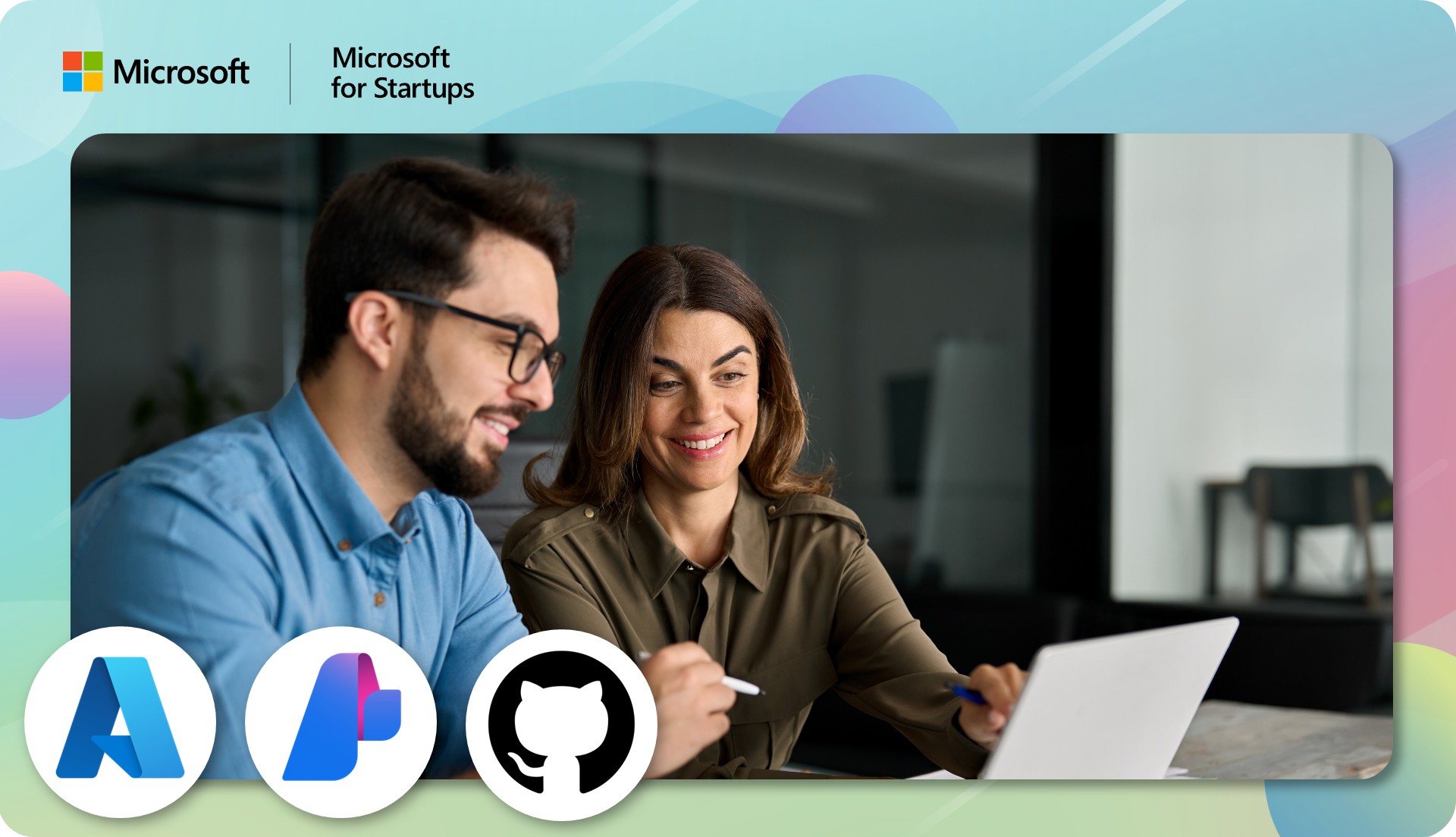 Two employees looking at a laptop screen