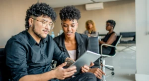 a group of people looking at a laptop