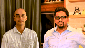 Trindev and Byreddy in separate photos joined together. Trindev is standing in front of a curtain and Byreddy is standing in his home.