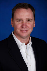 Mead smiles in a corporate photo.