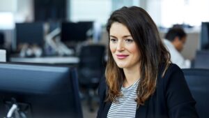 A woman works at her desk in a Microsoft open space.