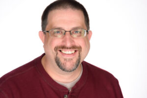 Patton smiles in a corporate photo.