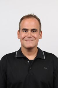 Gonis smiles in a corporate photo.