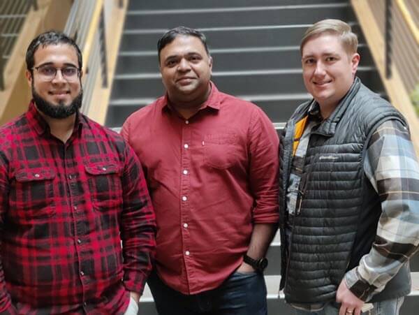 Ortiz, Tibdewal, and Reisinger smile in a corporate photo.