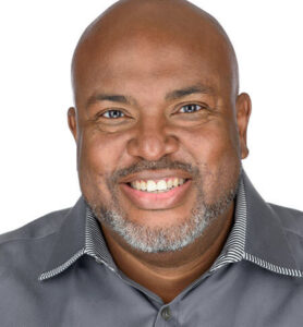 Jones poses for a portrait in a studio.