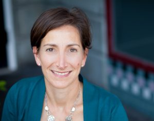 Friedman poses in a professional headshot.