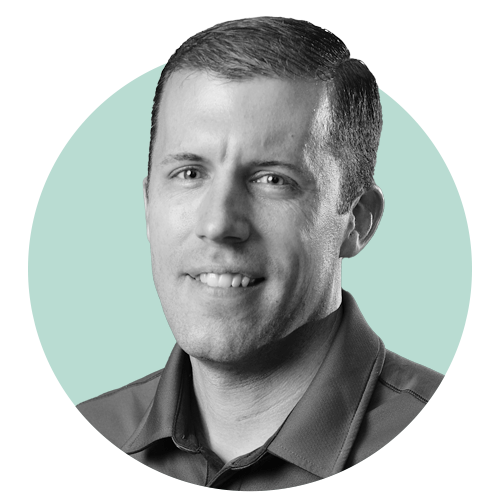 Weum smiles as he stands in the Microsoft Fargo office. 