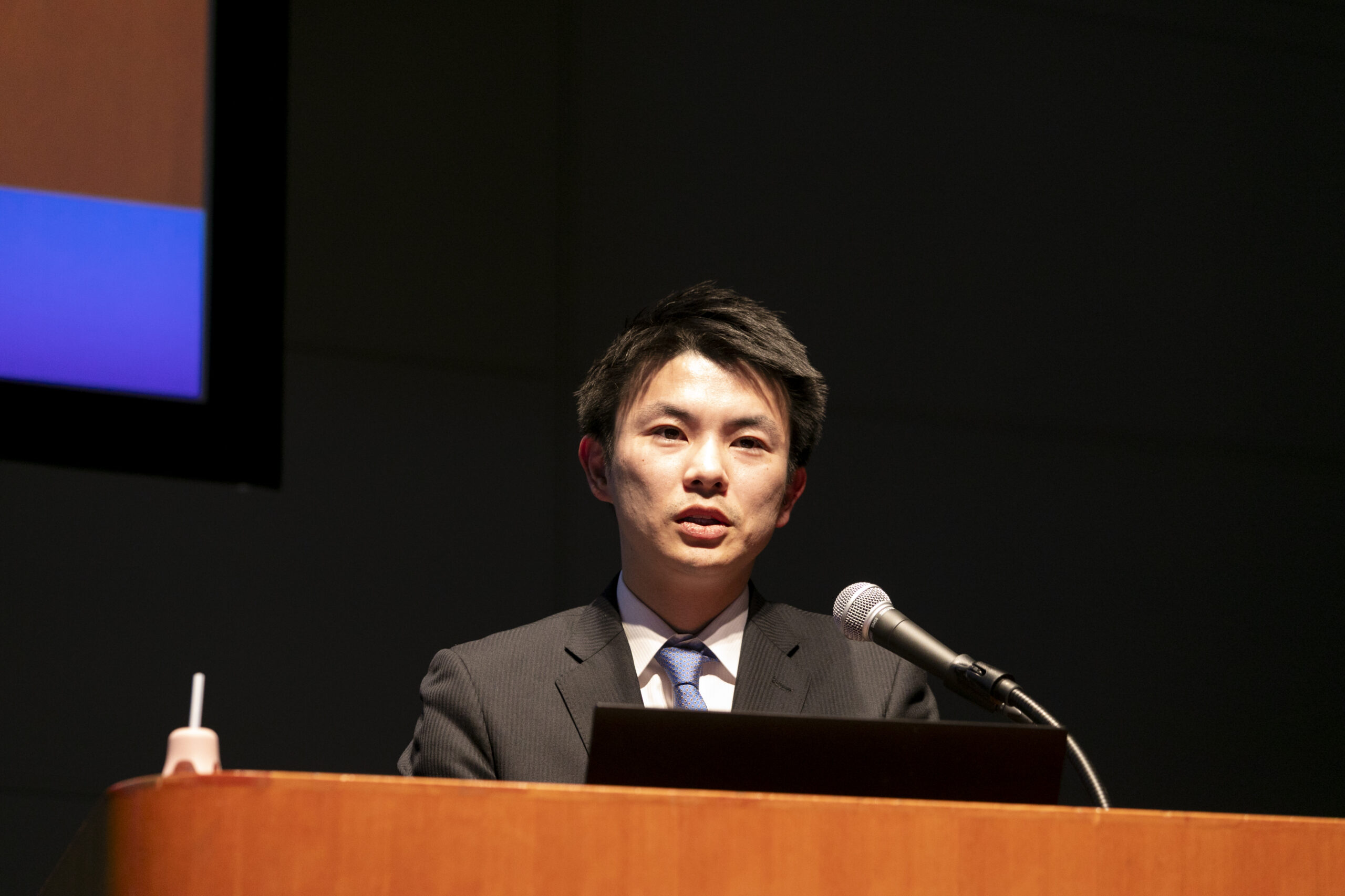 A man standing at a podium with a microphone
