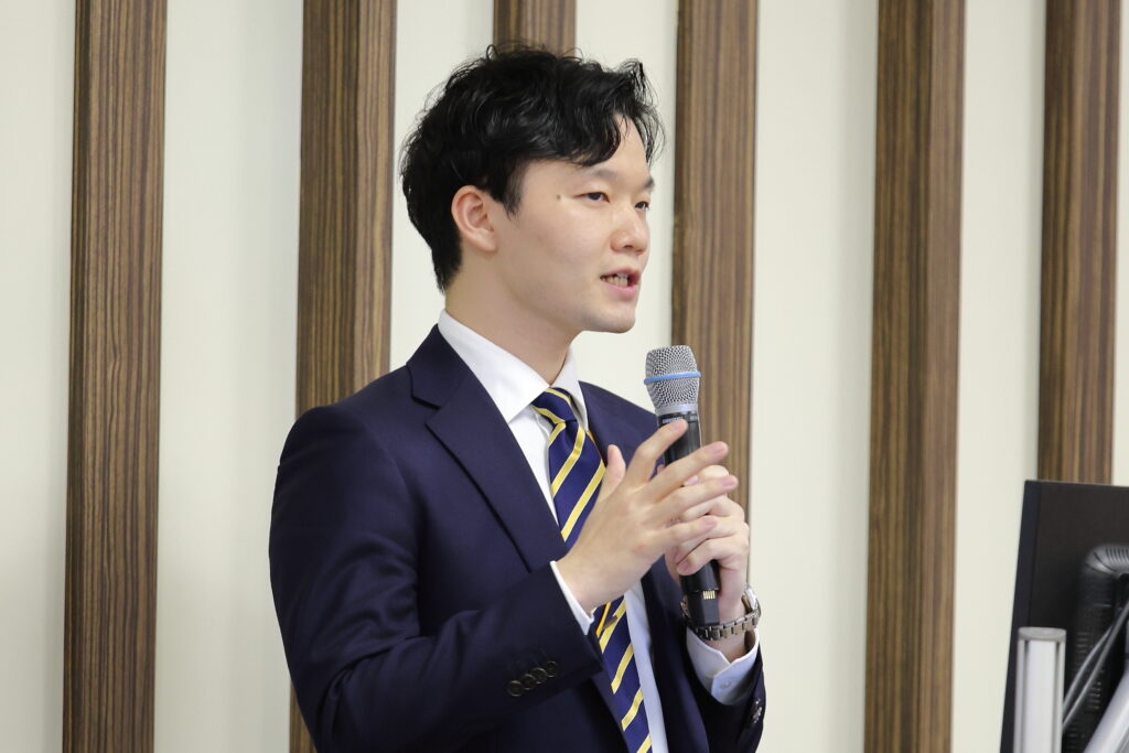 A man in a suit holding a microphone