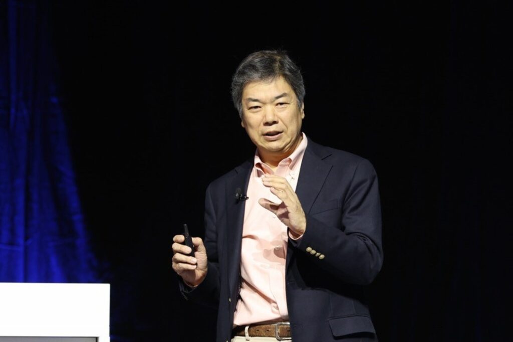 A man in a suit holding a device