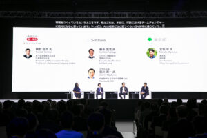 A group of people sitting in front of a large screen