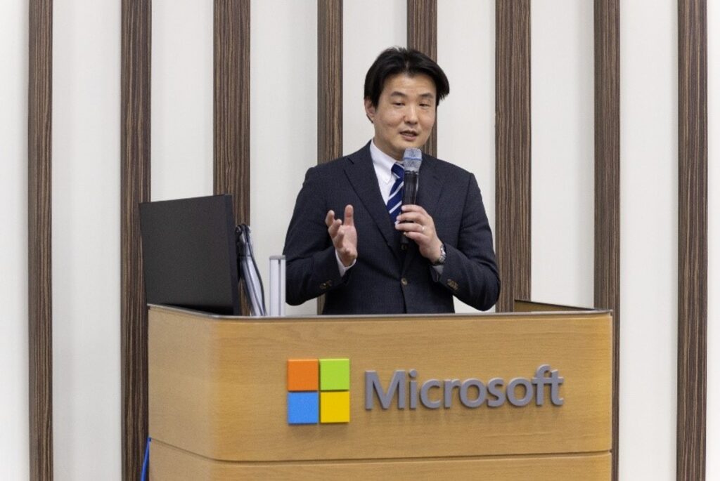 A man in a suit speaking into a microphone