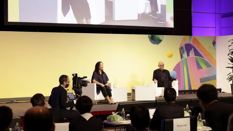 A group of people sitting on a stage