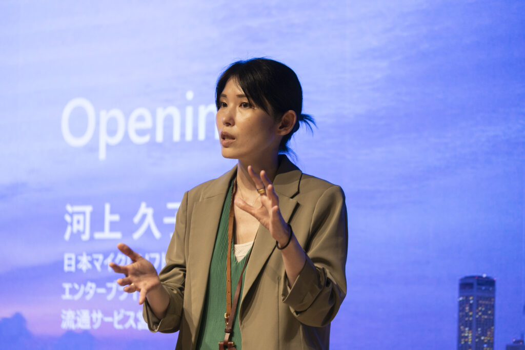 A woman standing in front of a screen