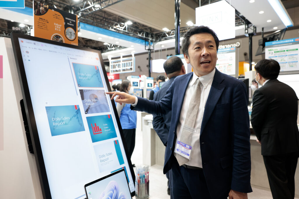 A man pointing at a large screen