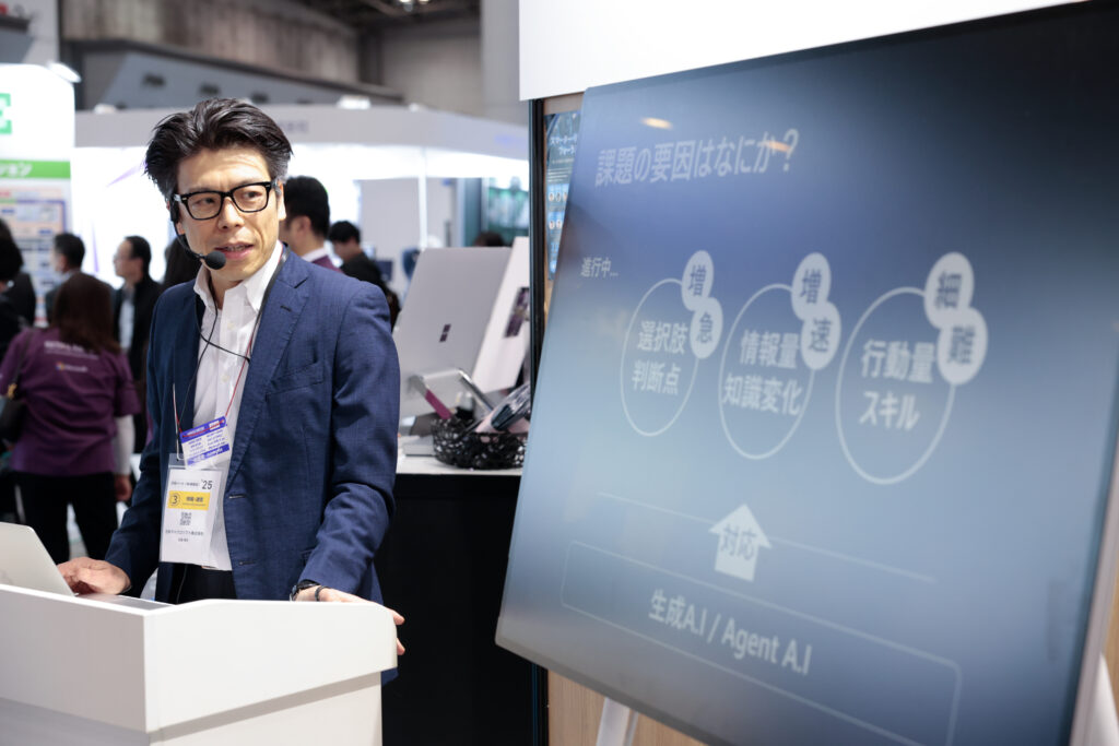 A man in a suit speaking at a podium