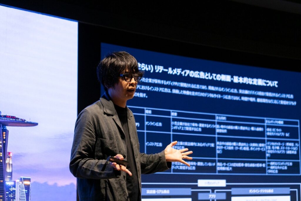 A man in glasses giving a presentation