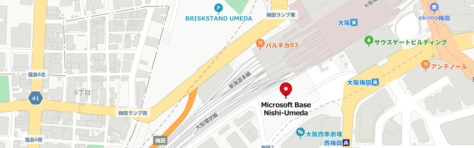 大阪梅田西周辺の地図で、複数の道路、鉄道線路、建物が描かれており、「Microsoft Base Nishi-Umeda」が赤ピンで示されています。
