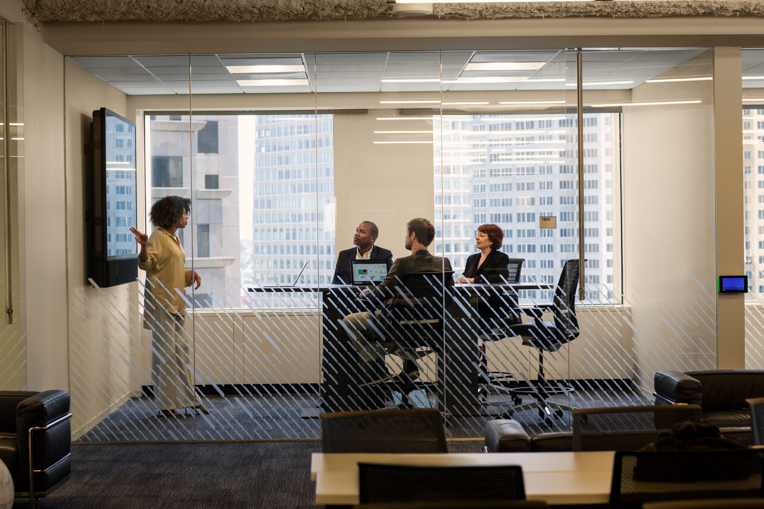 Sales team at large Financial Company. Group sales meeting and CEO presentation. Female sales manager presents product to CEO. ITPro, CFO and CEO meet with sales lead